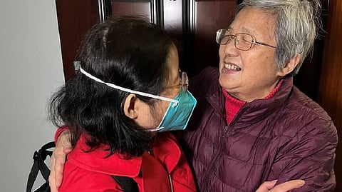 Chu Wenhong hugs her mother as she arrives from Singapore ahead of the Chinese Lunar New Year, her first time home since the coronavirus disease pandemic, in Shanghai, China