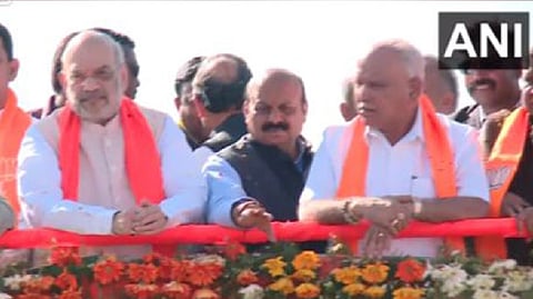 Union Home Minsiter Amit Shah (left), CM Bommai (centre), former CM Yediyurappa (right) during a roadshow in Dharwad
