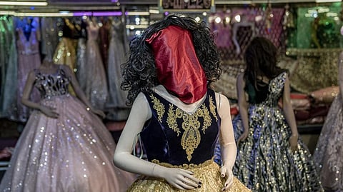 A mannequin's head is covered in a woman dress shop in Kabul