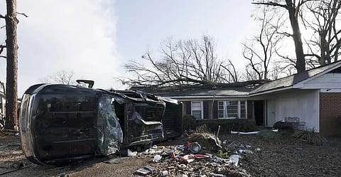 A vehicle is upended and debris is strewn about follow a tornado near Meadowview elementary school