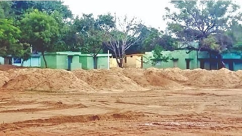 Sand dumped in the campus of the government higher secondary school at Vallimalai in Katpadi taluk