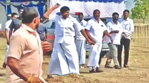 A video-grab of Minister Nasar throwing a stone at a party worker in Tiruvallur.