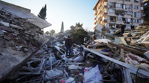A man walks through the rubble of destroyed buildings in Antakya, southern Turkey.