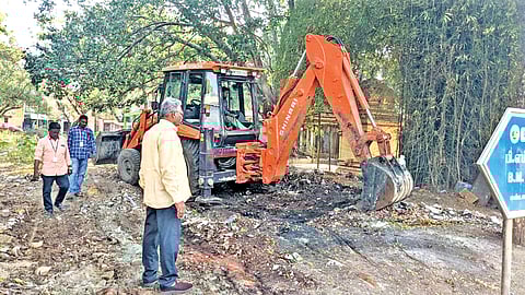Corporation officials clearing garbage at a ward with
earthmovers in Vellore