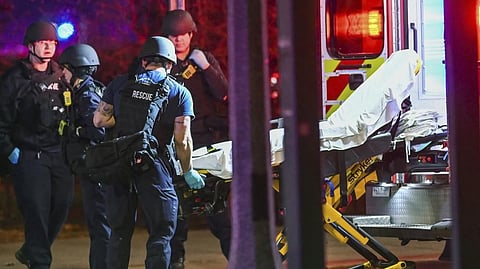 A stretcher is unloaded from an ambulance outside the Michigan State University Union following shootings on campus on Monday.
