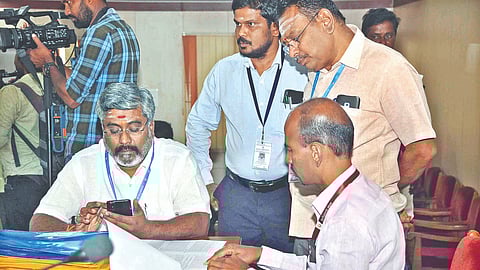 Election officials scrutinising the nomination papers for Erode bypoll on Wednesday