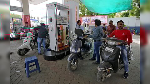 People get their two-wheelers filled with petrol at a fuel station in Ahmedabad, India.