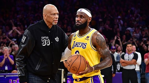 Los Angeles Lakers forward LeBron James meets with former player Kareem Abdul-Jabbar after breaking the NBA all time scoring record against the Oklahoma City Thunder during the second half at Crypto.com Arena
