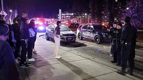 Students get directions from police on the campus of Michigan State University