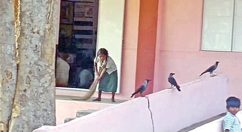 A Class 5 girl sweeping the verandah in the school at
Thirumalai Kuppam in Madanur, Tirupattur district