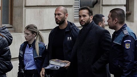 Andrew Tate and his brother Tristan are escorted by police officers outside the headquarters of the Bucharest Court of Appeal, in Bucharest, Romania, January 10, 2023.