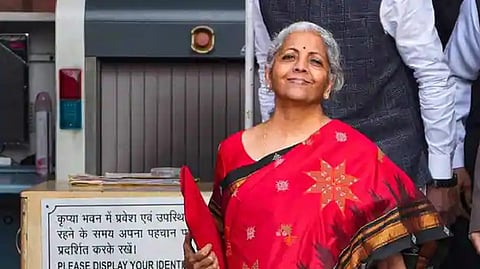 Finance Min Nirmala Sitharaman holds a folder-case containing Union Budget 2023-24 outside the Finance Ministry at North Block, in New Delhi.