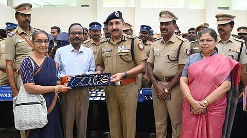 Avadi police commissioner Sandeep Rai Rathore handing over recovered stolen articles to a rightful owner on Tuesday