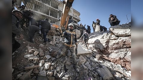 Rescuers in front of a damaged building after earthquake