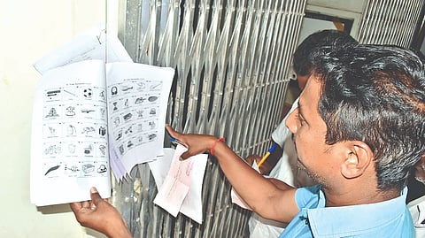 Independent candidates choose their symbols from the
list put up at the election office in Erode on Friday