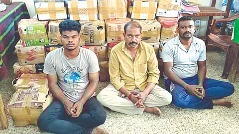 The three smugglers and seized IMFL bottles in Thanjavur on Monday