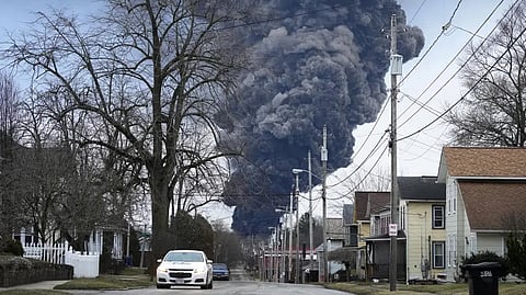 A black plume rises over East Palestine, Ohio, as a result of a controlled detonation of a portion of the derailed Norfolk and Southern trains