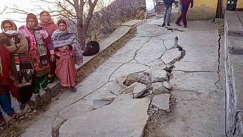 People affected by the gradual "sinking" of Joshimath in Chamoli district of Uttarakhand after cracks appeared in their houses, in Joshimath