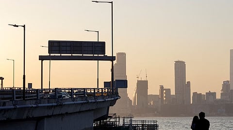 People stand at a shore in Hong Kong, China