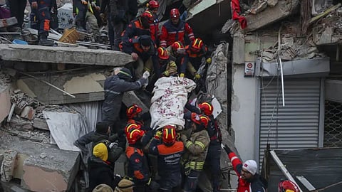 Turkish rescue workers carry Ergin Guzeloglan, 36, to an ambulance after pulled him out from a collapsed building five days after an earthquake in Hatay, southern Turkey