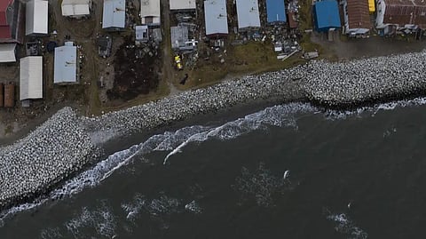 Small waves crash into reinforced seawalls in Shishmaref