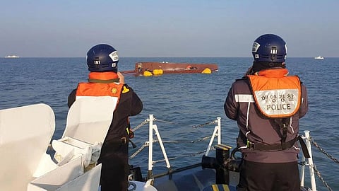 Coast guard members searching for missing people after a fishing boat capsized in waters off the coast of Sinan county on Feb 5.