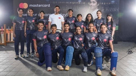 Mahendra Singh Dhoni with  a group of aspiring under-19 women cricketers