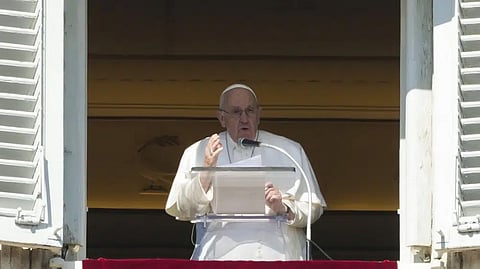 Pope Francis delivers his speech during the Angelus noon prayer from the window of his studio overlooking St.Peter's Square