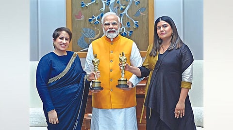 Prime Minister Narendra Modi with The Elephant Whisperers producer Guneet Monga (l) and director Kartiki Gonsalves in New Delhi Thursday