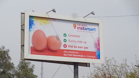 Picture of Swiggy's Instamart billboard themed on Holi festival.