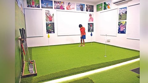 A child tries his hand at indoor golf in Chennai.