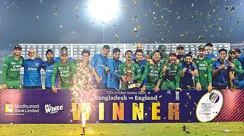 The victorious Bangladesh team poses with the trophy
