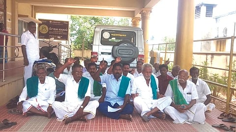 Farmers staging a sit-in at Nemili taluk office against revenue department officials in Ranipet on Thursday