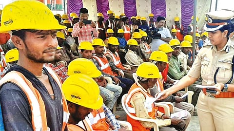 CoP M Sathyapriya distributing awareness bills to the migrant workers in Tiruchy on Saturday