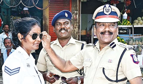Vellore Range DIG Muthusamy handing over cooling glasses to a traffic cop