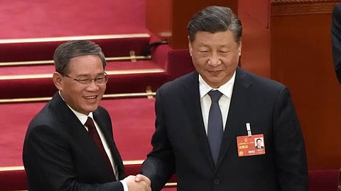 Li Qiang, left, shakes hands with Chinese President Xi Jinping
