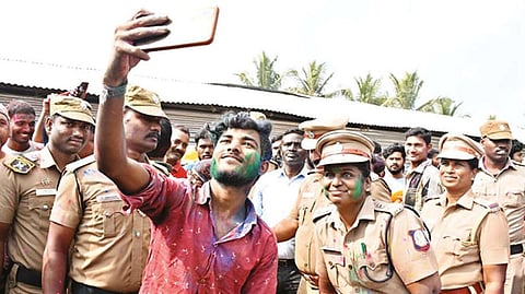 Perambalur SP C Shyamaladevi and cops celebrate Holi with migrant workers on Thursday.