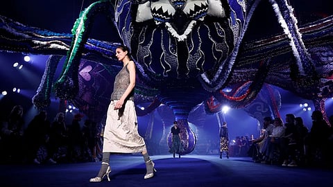 Models present creations by designer Maria Grazia Chiuri