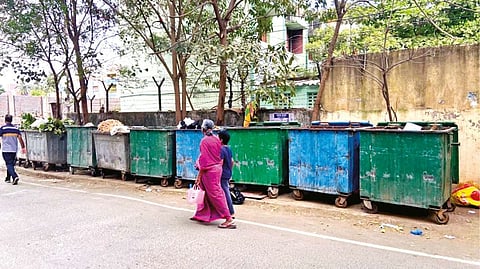 Multiple garbage bins on Venkatesh Nagar Main Road at Virugambakkam.