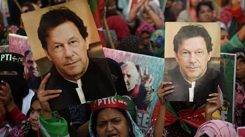 Supporters of Pakistan's former prime minister Imran Khan, carry placards displaying a portrait of Khan during a protest in Karachi