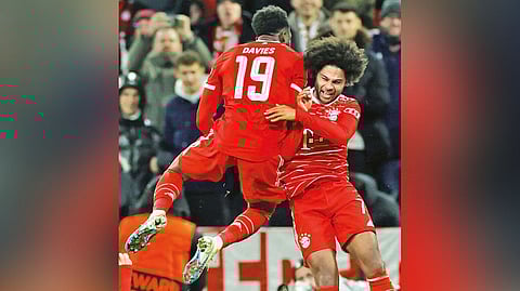 Serge Gnabry (right) celebrates with Alphonso Davies after putting the Round-of-16 tie to bed