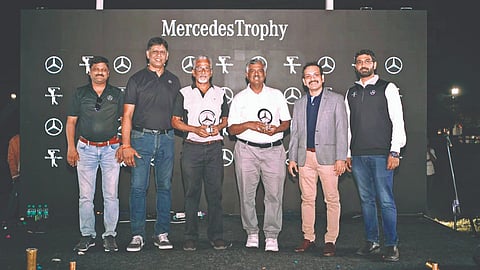 RG Shrinivas and P Krishnan, MGC honorary sub-secretary for golf, with the Mercedes Benz trophy