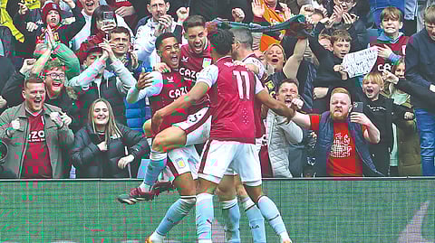 Aston Villa players celebrate
scoring a goal