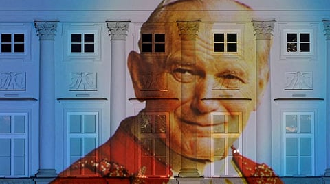 A picture of Pope John Paul II is displayed on the facade of the Presidential Palace in Warsaw, Poland.