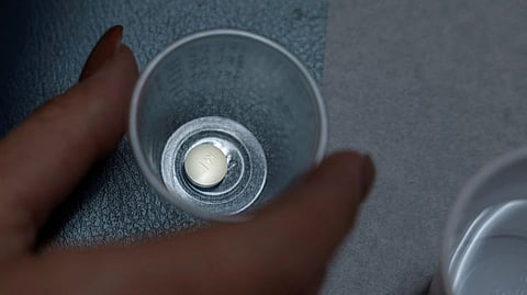 A patient prepares to take mifepristone, the first pill given in a medical abortion, at Women's Reproductive Clinic of New Mexico in Santa Teresa.