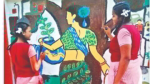 Students engaged in wall art