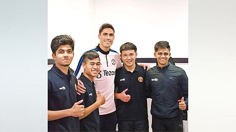 Preyarhanjan (extreme left) with Manchester United defender Raphael Varane (centre)