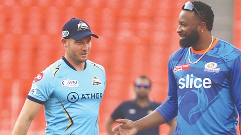 Gujarat?s David Miller has a
chat with Mumbai batting
coach Kieron Pollard