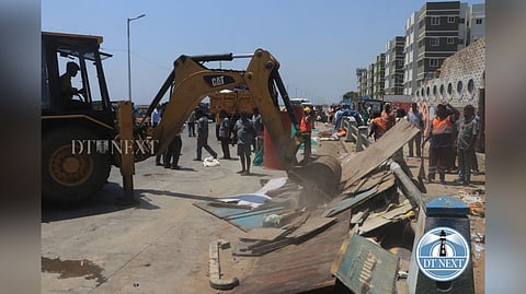 A JCB mowing down a fish stall