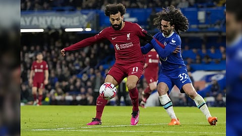 Liverpool's Mohamed Salah, left, duels for the ball with Chelsea's Marc Cucurella during the English Premier League soccer match between Chelsea and Liverpool at Stamford Bridge stadium in London, Tuesday, April 4, 2023